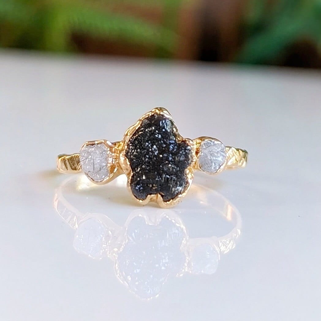 Raw uncut Black Diamond engagement ring with small diamonds on a 14k Gold band, handcrafted and unique.