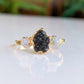 Raw uncut Black Diamond engagement ring with small diamonds on a 14k Gold band, handcrafted and unique.
