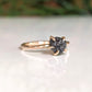 Raw black diamond engagement ring in solid 14k gold, showcasing a 7-8mm uncut diamond on a prong band.
