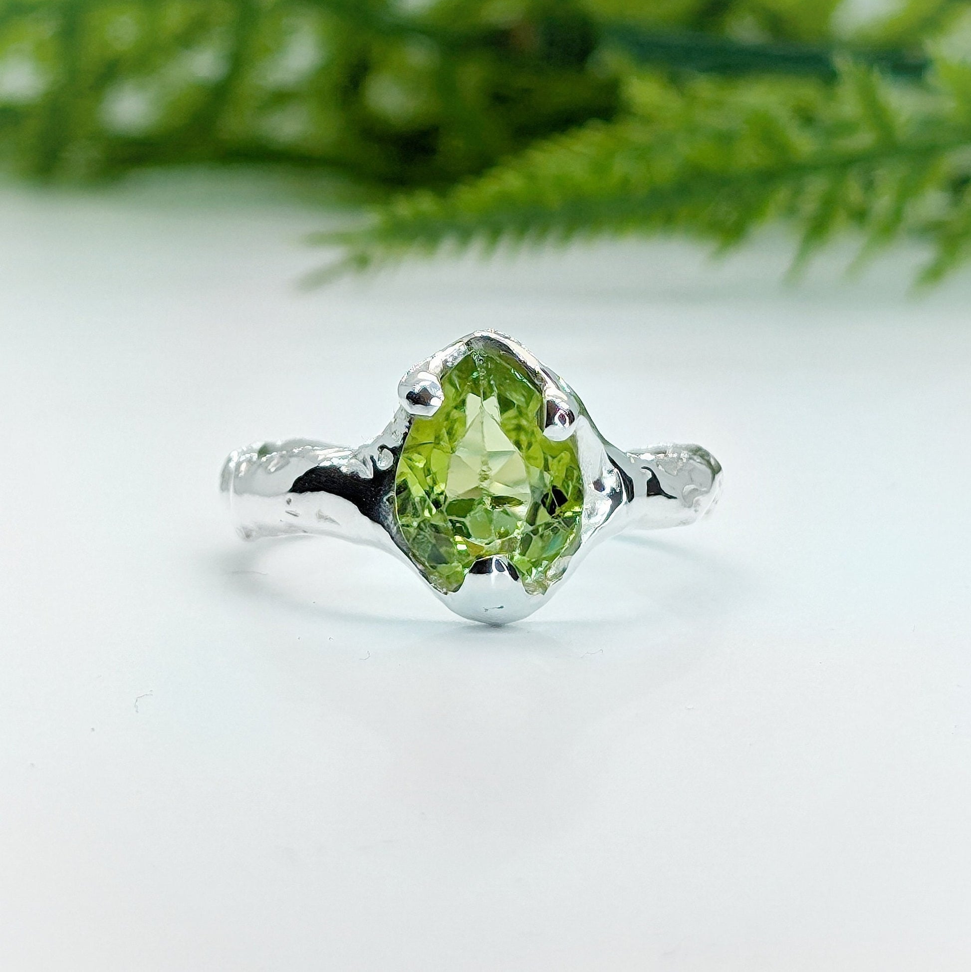 Handcrafted rose cut Peridot ring in sterling silver with organic textured band, showcasing the beauty of nature.