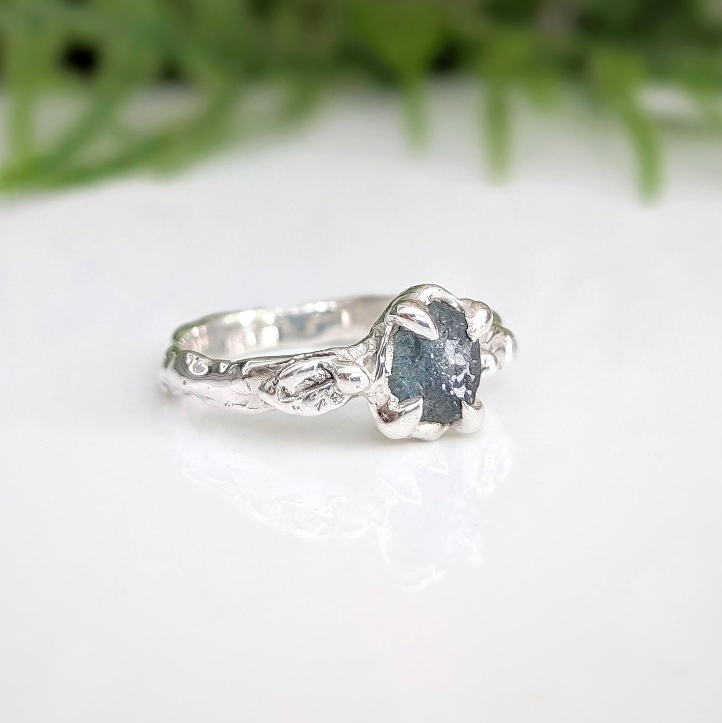 Raw Montana Sapphire ring in sterling silver with an organic molten band, showcasing teal blue-green hues.
