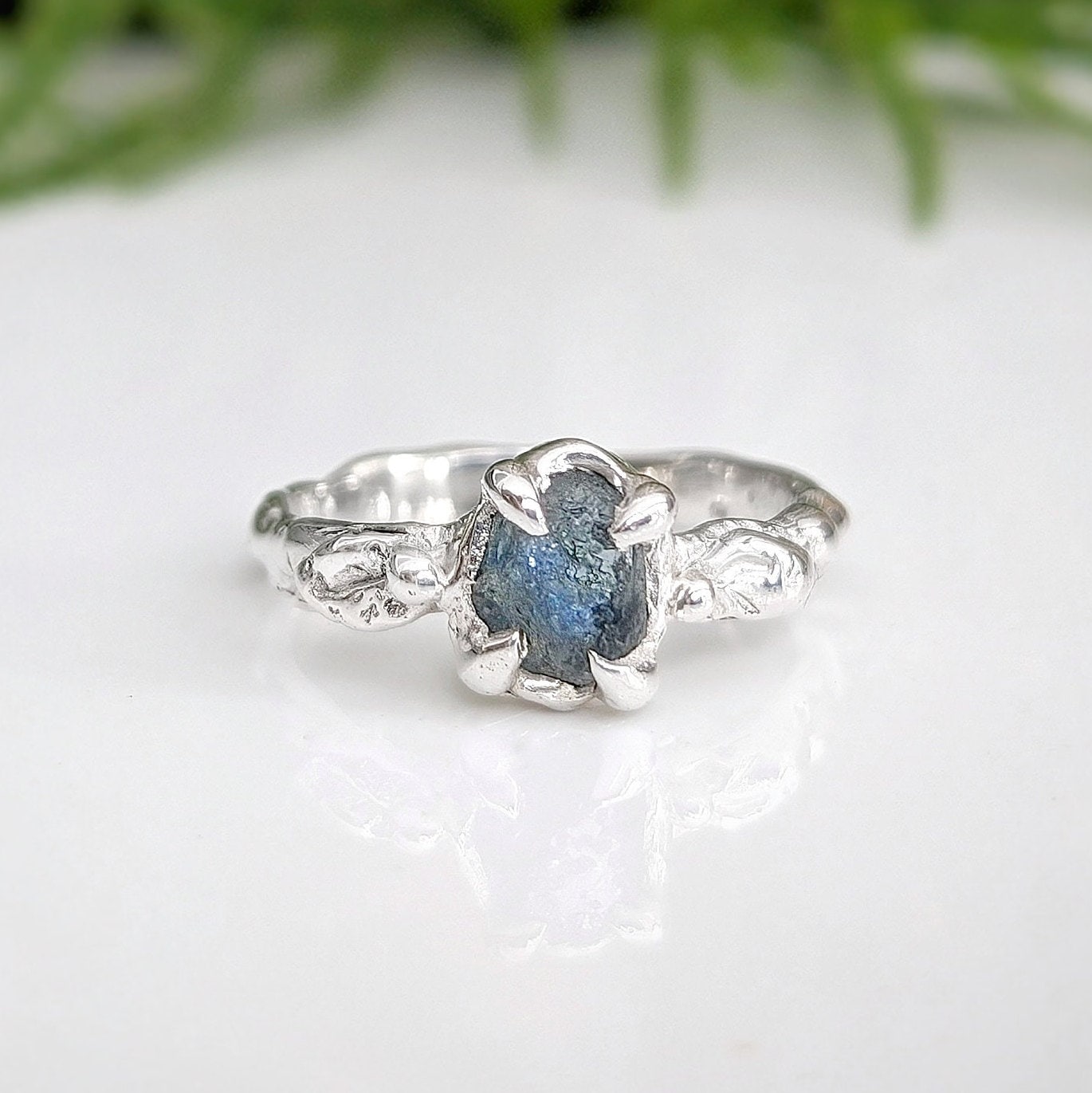 Raw Montana Sapphire silver ring with organic molten band, showcasing teal blue-green natural beauty.