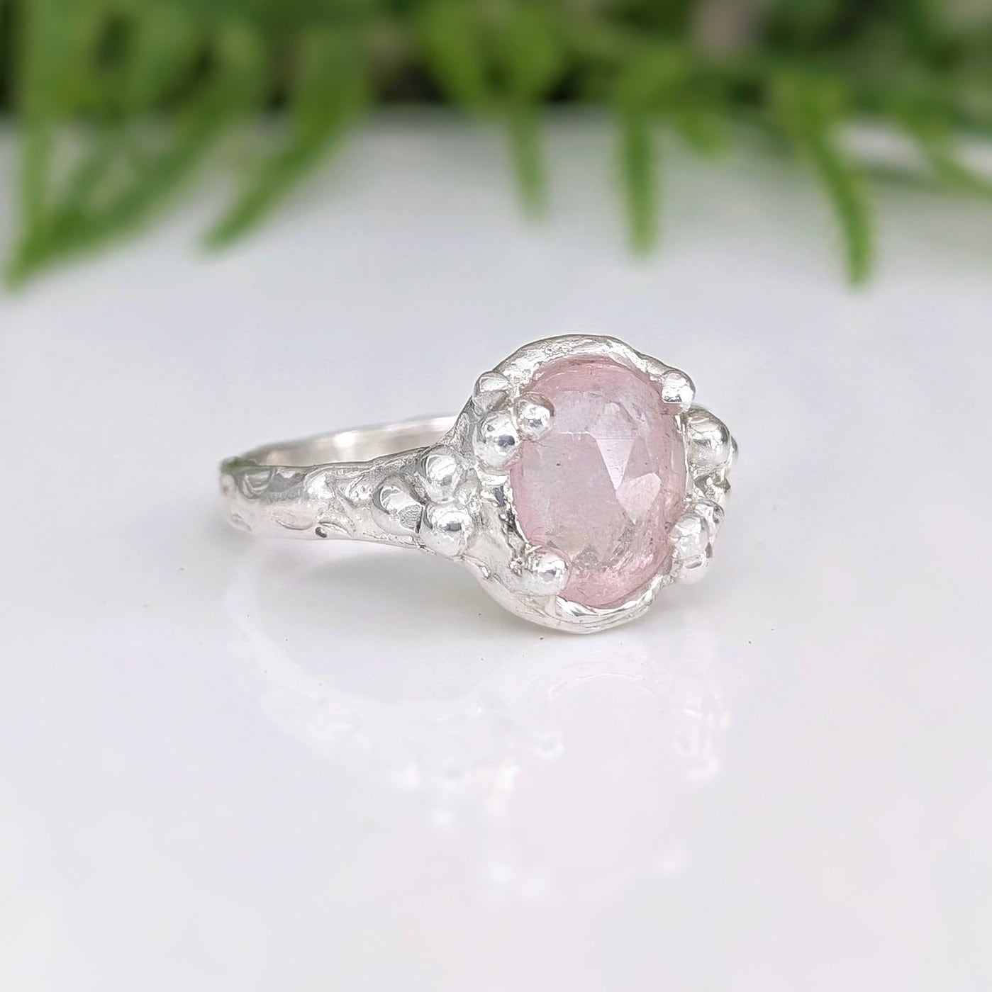 Handcrafted pink Morganite engagement ring in sterling silver with nature-inspired design.