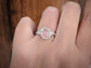 Pink Morganite engagement ring on a hand, featuring a sterling silver setting with floral accents.