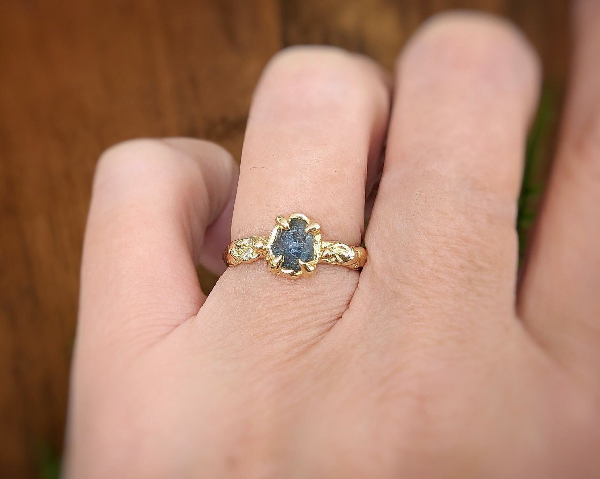 Raw Montana Sapphire engagement ring crafted in solid 14k gold, featuring a unique organic band design.