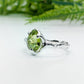 Handcrafted sterling silver ring featuring a stunning rose cut Peridot, showcasing a unique organic textured band.