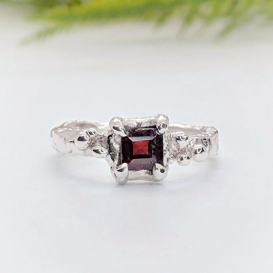 Red Garnet engagement ring in solid sterling silver with a unique organic textured band.