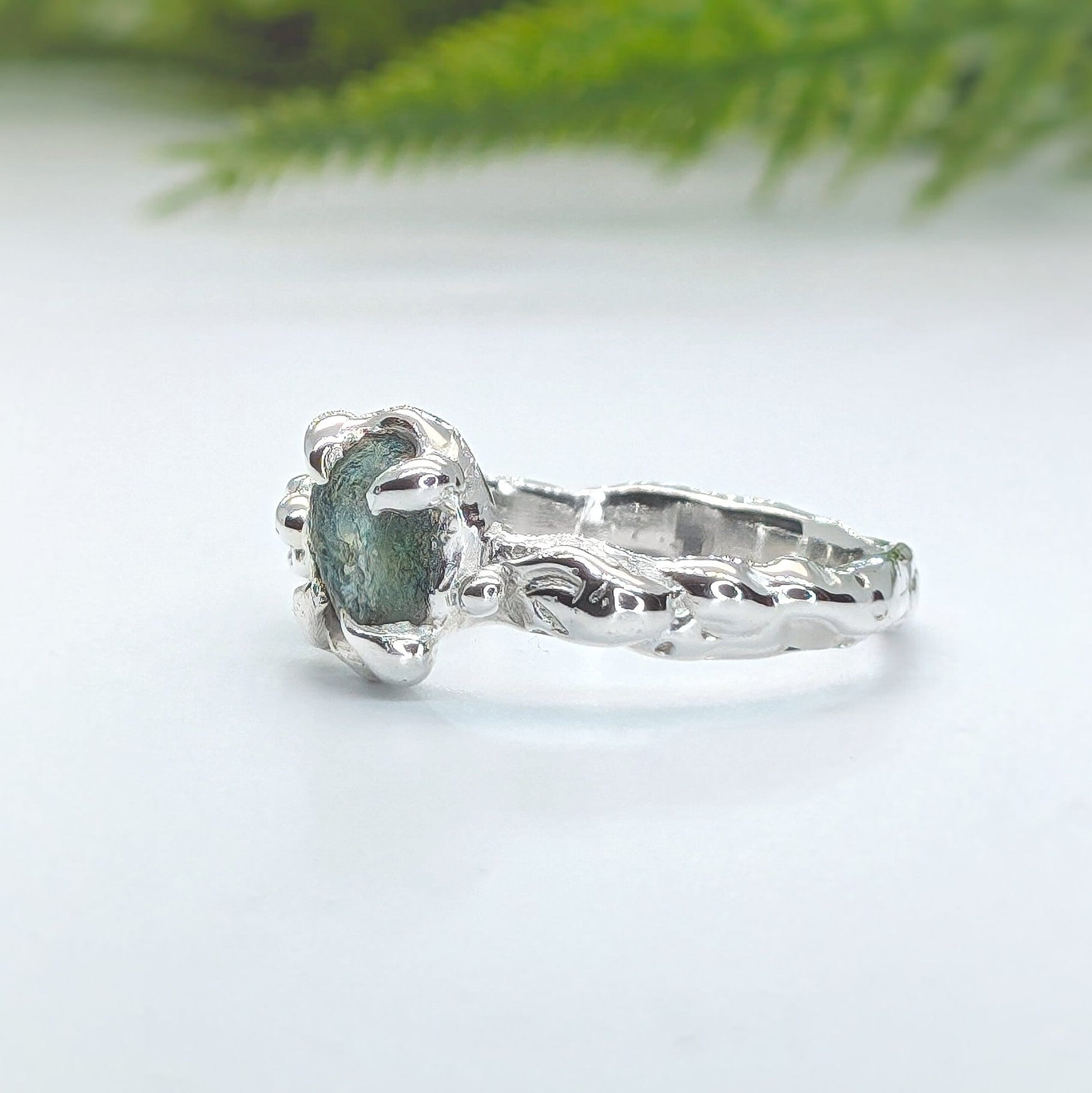 Raw Montana Sapphire ring in sterling silver, showcasing teal blue-green stone with an organic molten band.