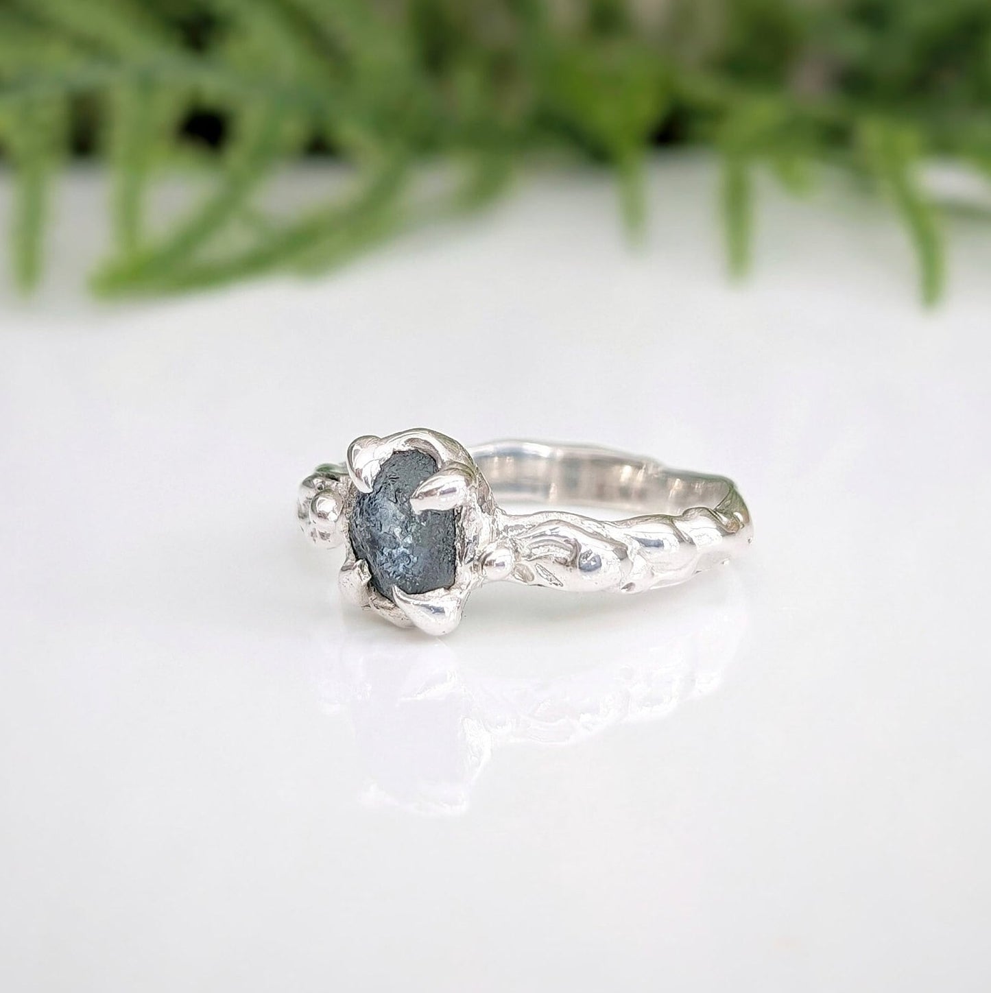 Raw Montana Sapphire silver ring with organic band, handcrafted and unique engagement ring featuring teal blue-green gemstone.