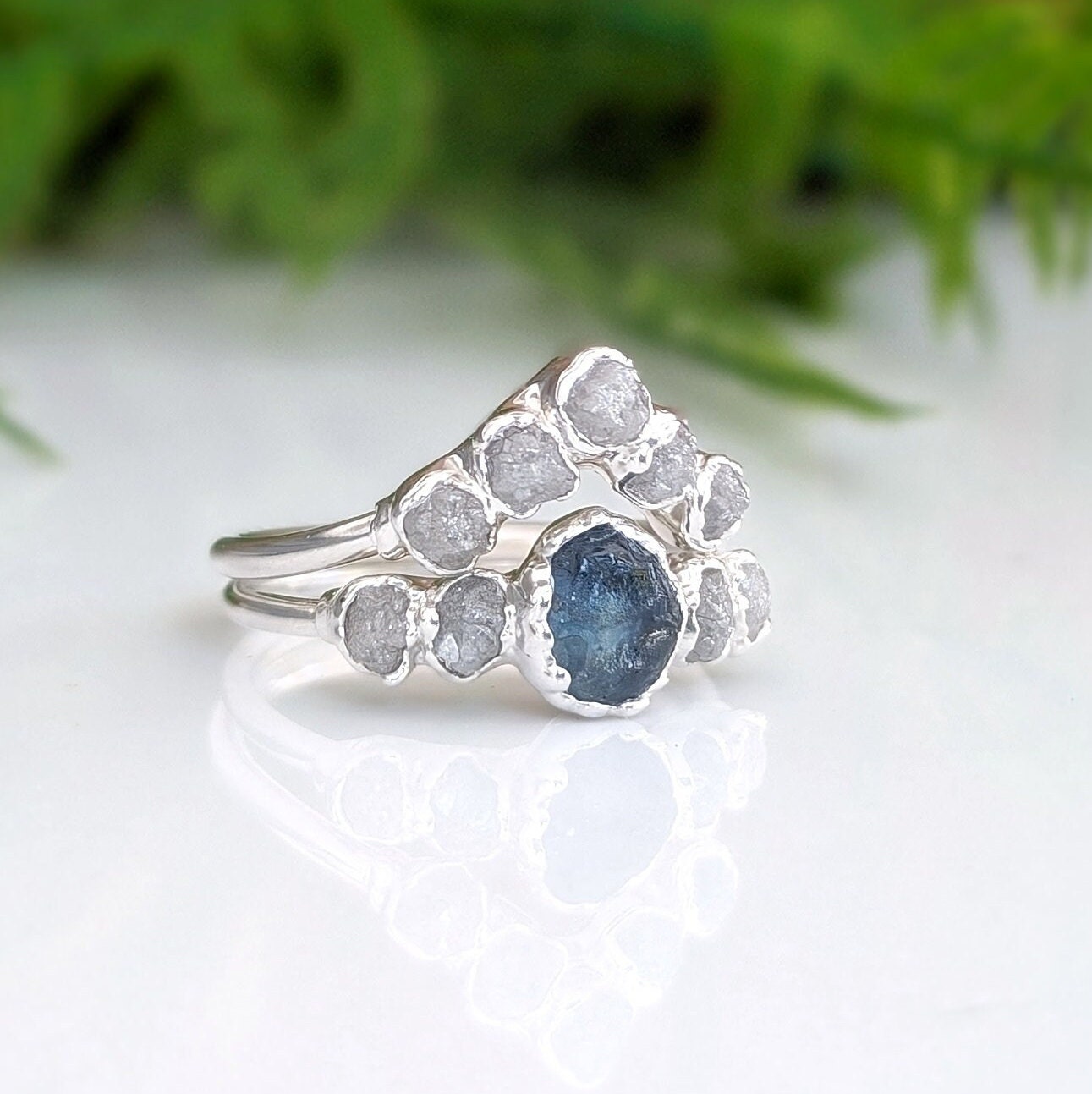 Raw Montana sapphire and diamond bridal ring set in sterling silver, featuring a teal sapphire and raw diamond accents.