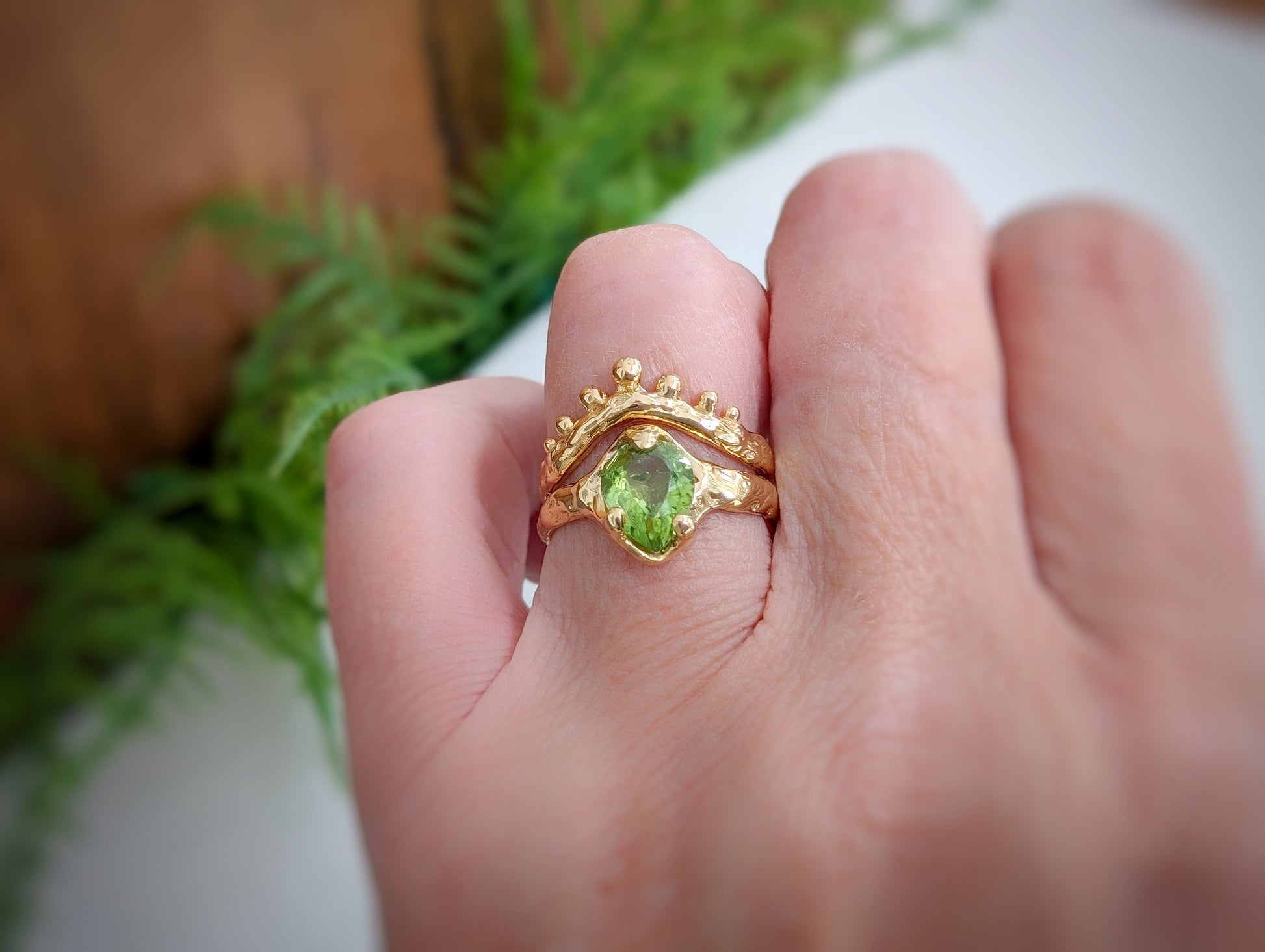 Handcrafted Peridot ring in solid 14k gold, featuring an organic textured band and unique design.