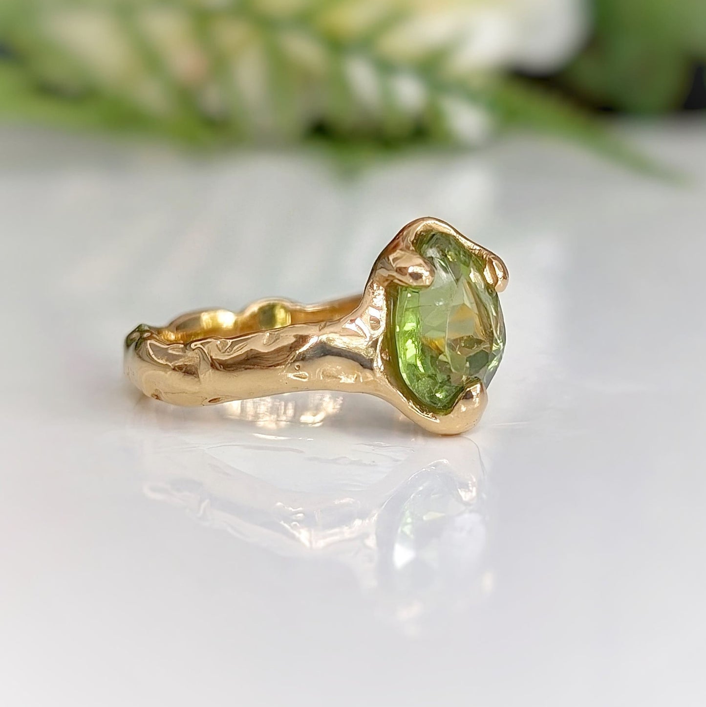 Stunning peridot ring in solid 14k gold with organic textured band, perfect as a unique engagement ring.
