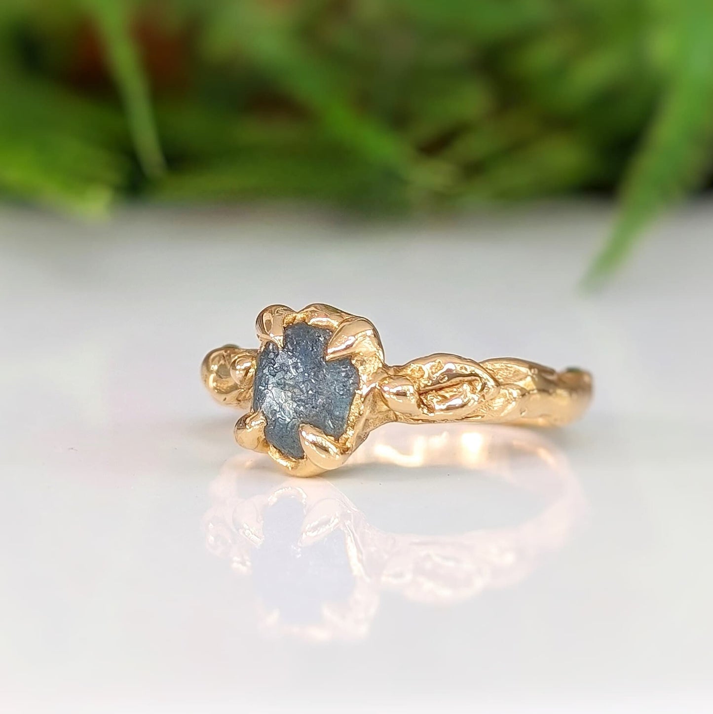 Raw Montana Sapphire engagement ring in solid 14k gold, showcasing organic texture and unique design.