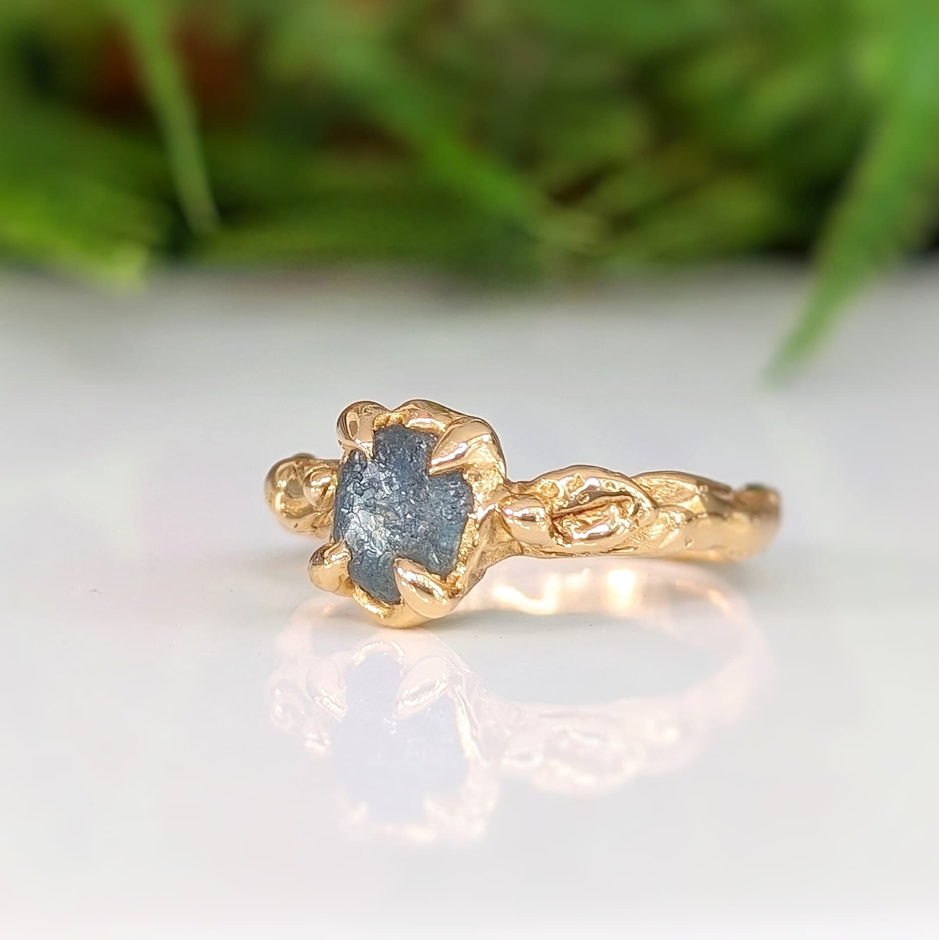 Raw Montana Sapphire engagement ring in solid 14k gold, showcasing organic texture and unique design.
