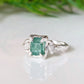Raw emerald and diamond engagement ring in solid 14k gold with nature-inspired design.