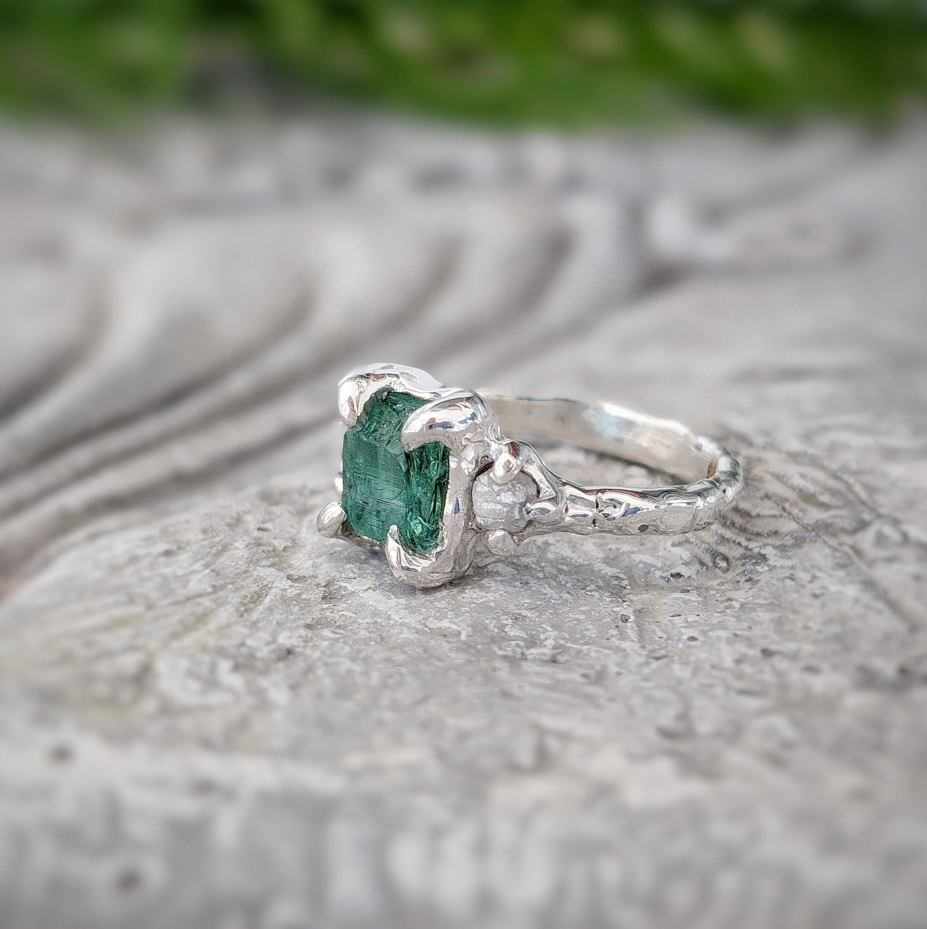 Raw emerald and diamond engagement ring in solid 14k gold, showcasing a unique mint green raw emerald.