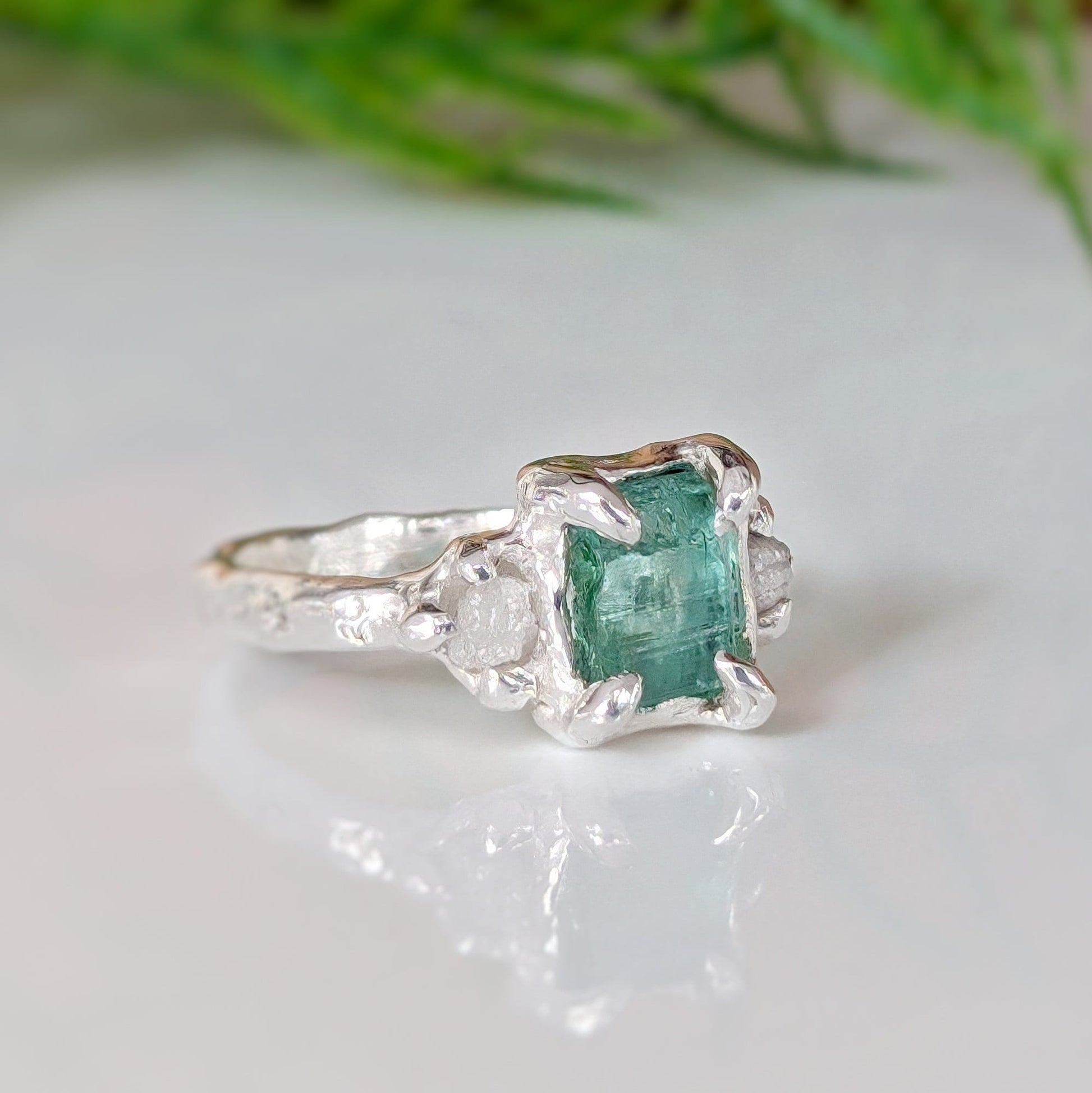 Raw emerald and diamond engagement ring in solid 14k gold, handcrafted with mint green emerald and two small raw diamonds.