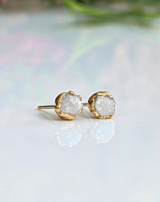 Ethically sourced raw diamond stud earrings with gold settings, showcasing natural uncut beauty and timeless elegance.