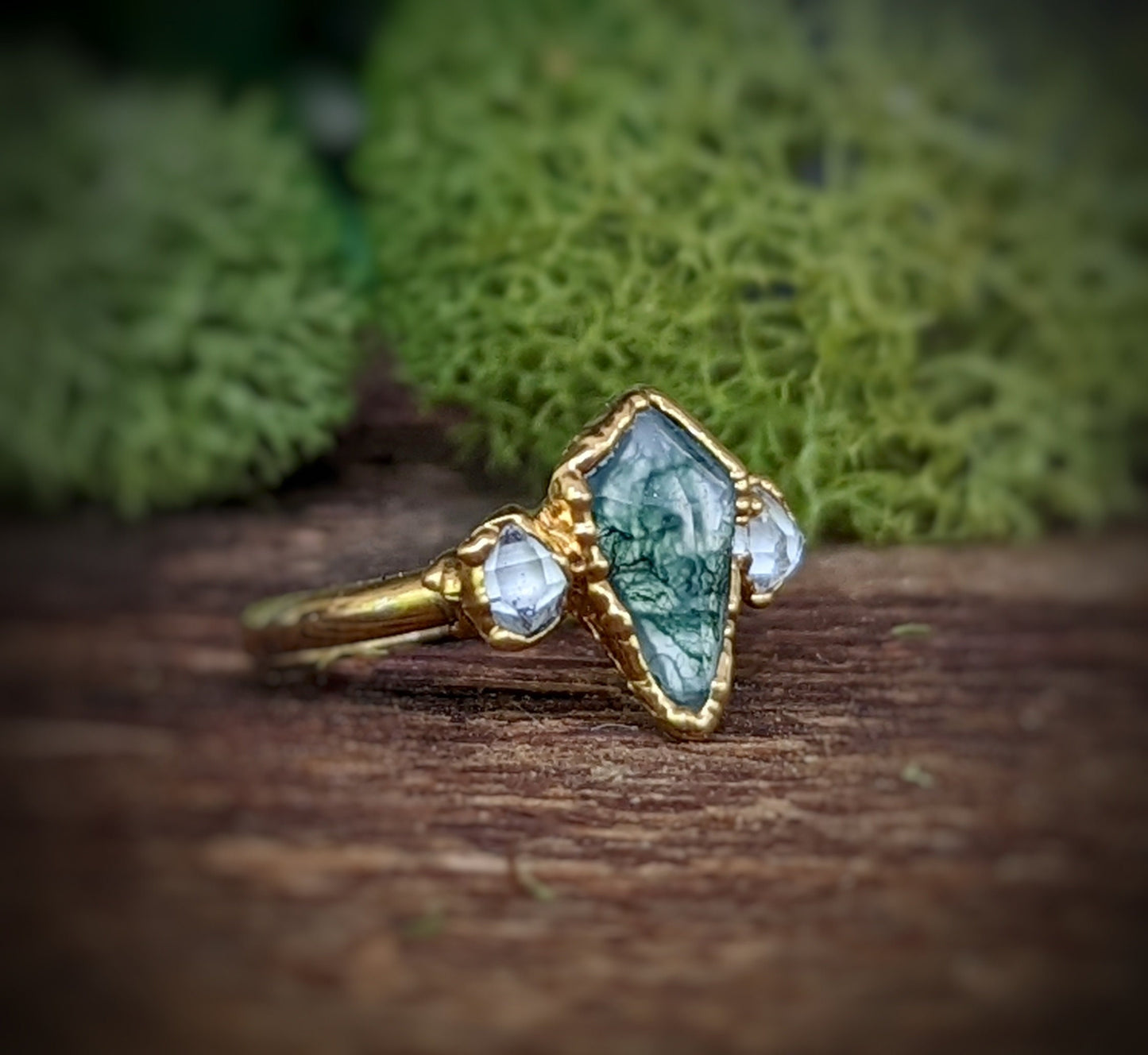 Kite-shaped Moss Agate and Herkimer diamond ring, handcrafted gold setting with unique organic charm.