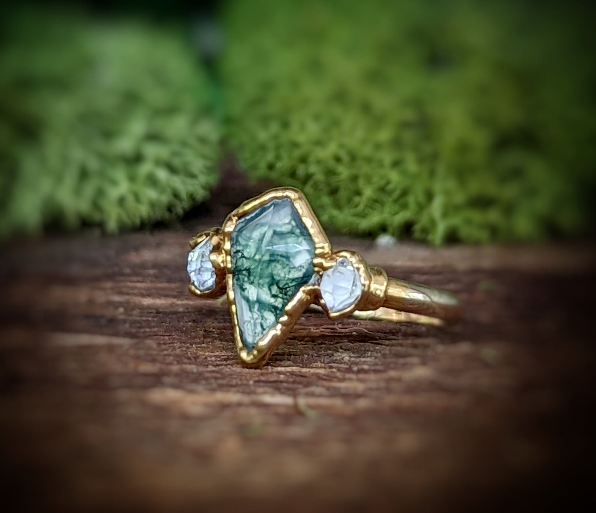 Kite-shaped Moss Agate and Herkimer diamond ring with gold setting, showcasing unique handmade design.
