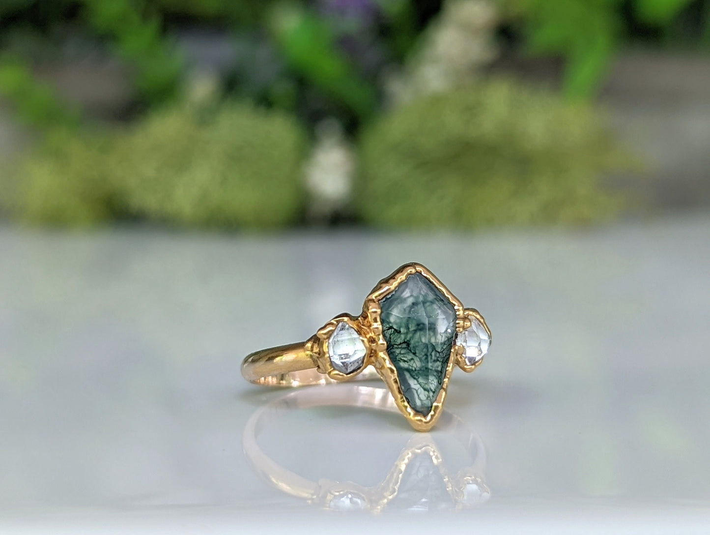 Kite-shaped Moss Agate and Herkimer diamond ring, handcrafted in gold, symbolizing love and friendship.