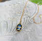 Labradorite Kintsugi necklace with gold plating and 21" chain, set against a textured stone background.