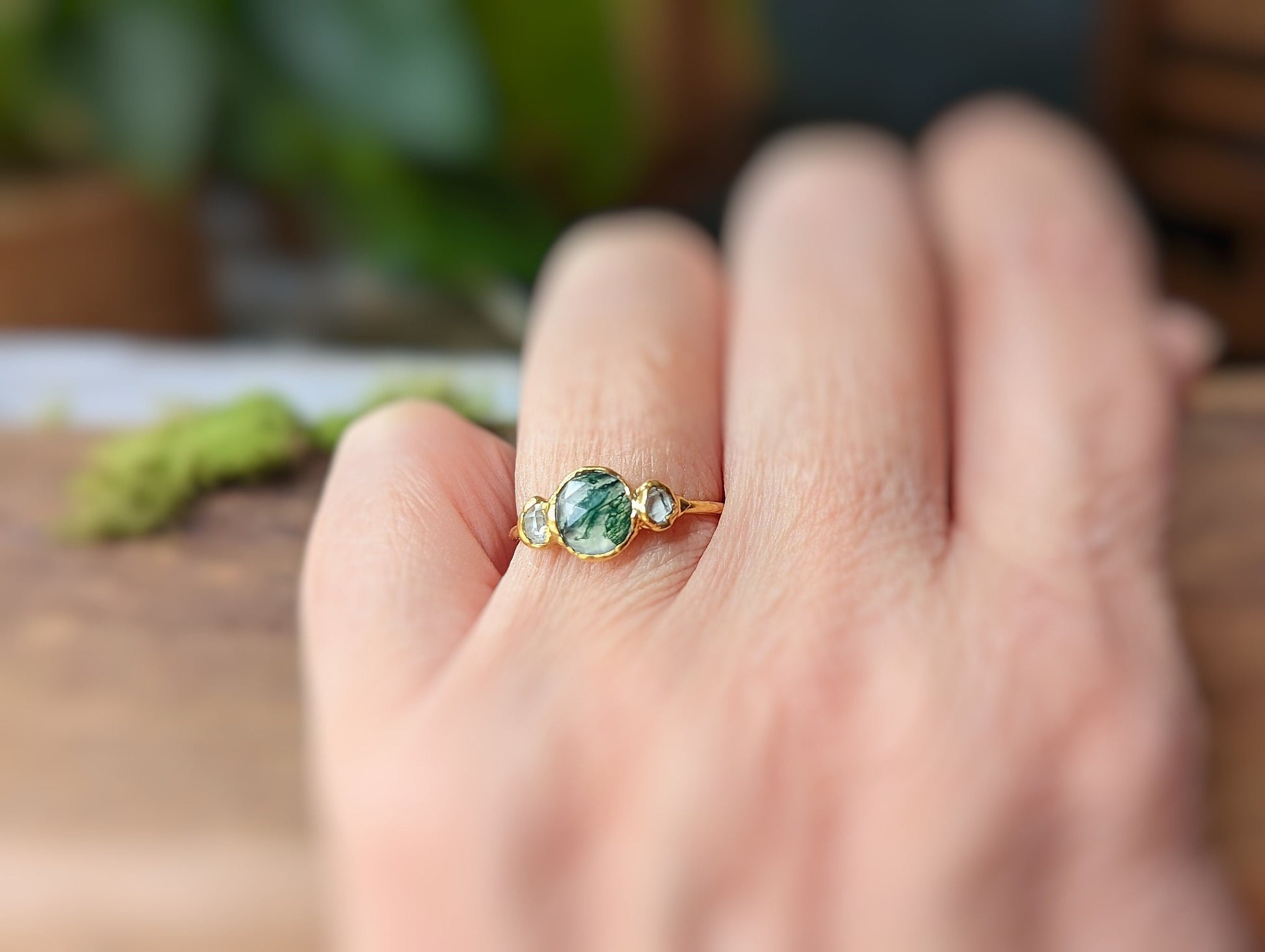Handcrafted Moss Agate ring with Herkimer diamonds on an 18k gold band, showcasing natural beauty and elegance.