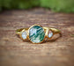 Moss Agate and Herkimer diamond engagement ring on a gold band, showcasing natural beauty and unique design.