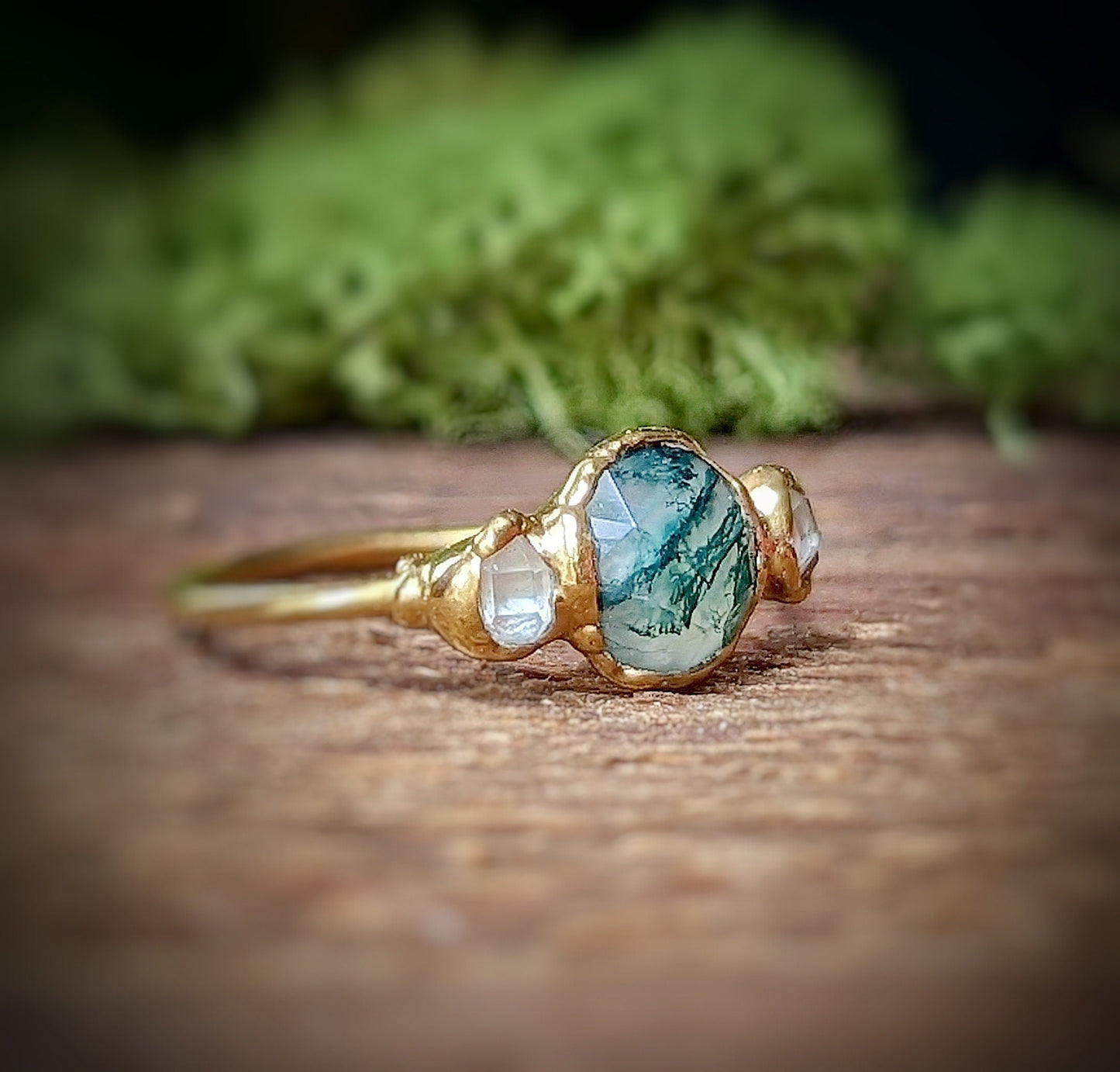 Moss Agate ring with Herkimer diamonds set in an 18k Gold band, showcasing unique natural beauty.