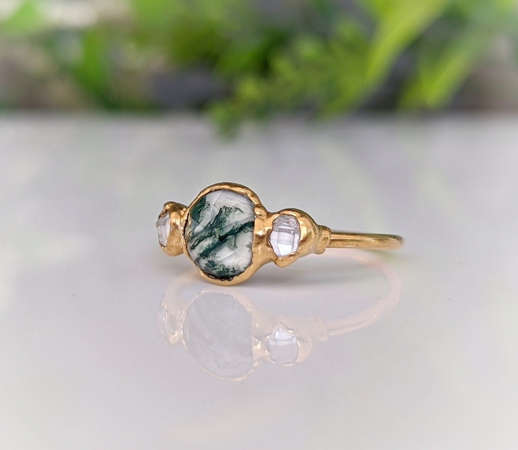 Moss Agate and Herkimer diamond engagement ring on a gold band, showcasing natural beauty and unique design.