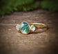 Moss Agate ring with Herkimer diamonds, set on an 18k gold band, showcasing unique craftsmanship and natural beauty.
