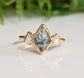 Moss Agate and Herkimer diamond engagement ring in lozenge shape set on a gold band, showcasing natural beauty.