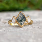 Lozenge-shaped Moss Agate engagement ring with Herkimer diamonds on a gold band, showcasing unique natural beauty.
