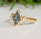 Lozenge shape Moss Agate and Herkimer diamond engagement ring on a gold band.