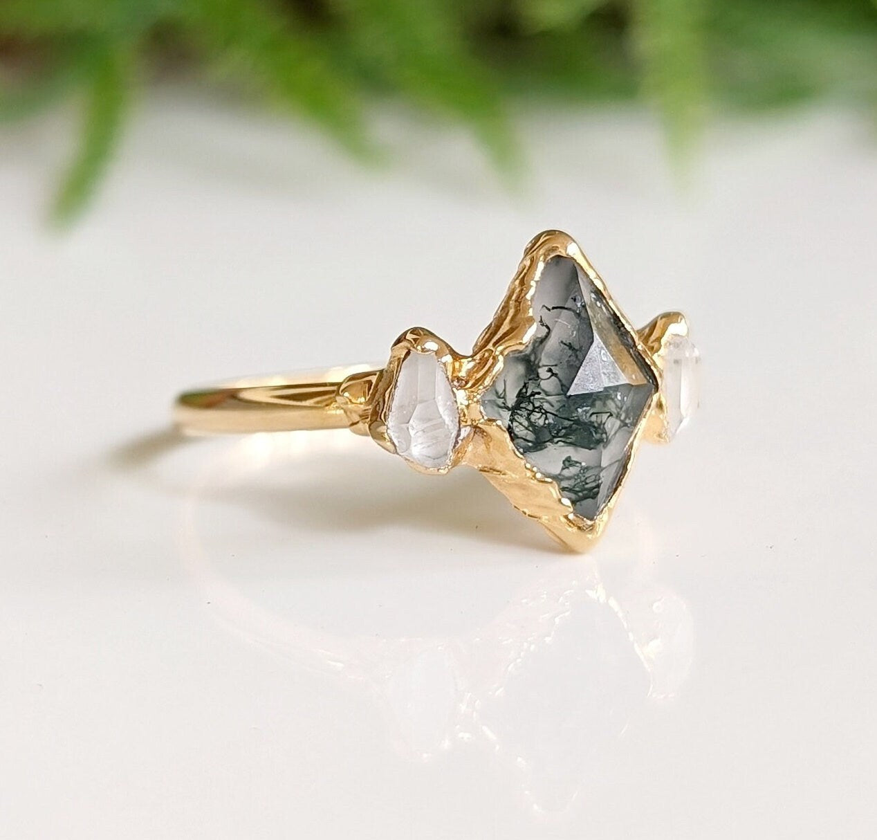 Moss Agate lozenge engagement ring with Herkimer diamonds on a 14k gold band, showcasing nature-inspired elegance.