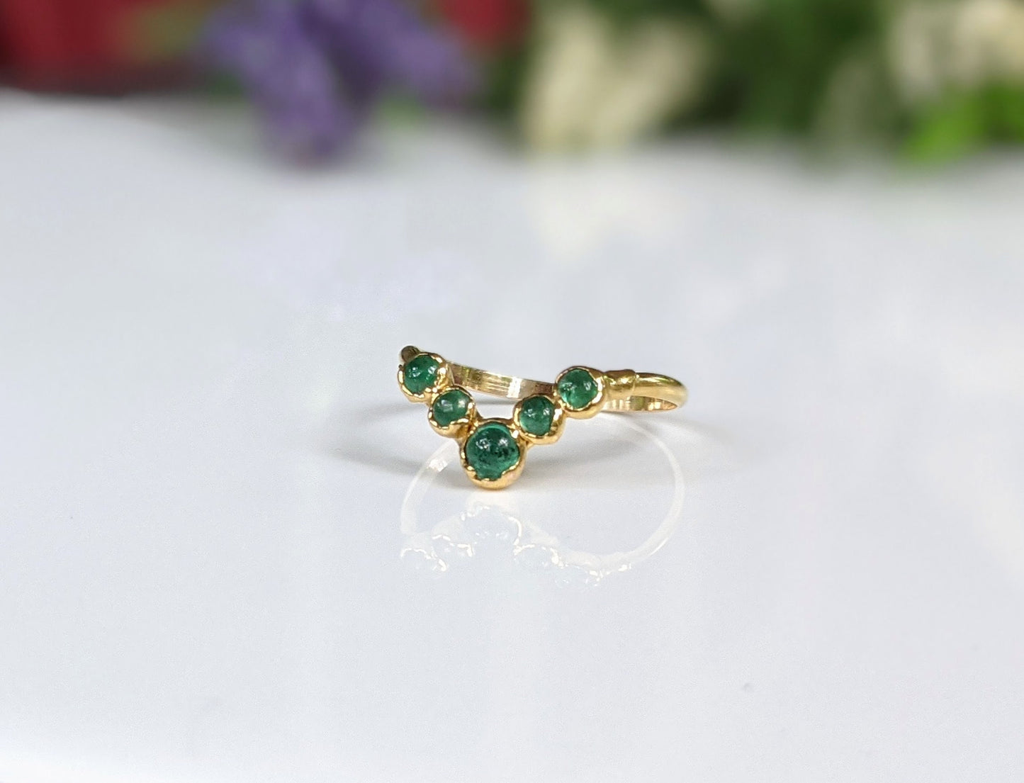 Natural Emerald Chevron wedding ring in 18k Gold showcases stunning green gemstones, ideal for love and anniversaries.