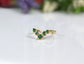 Natural Emerald Chevron wedding ring in 18k Gold showcases stunning green gemstones, ideal for love and anniversaries.