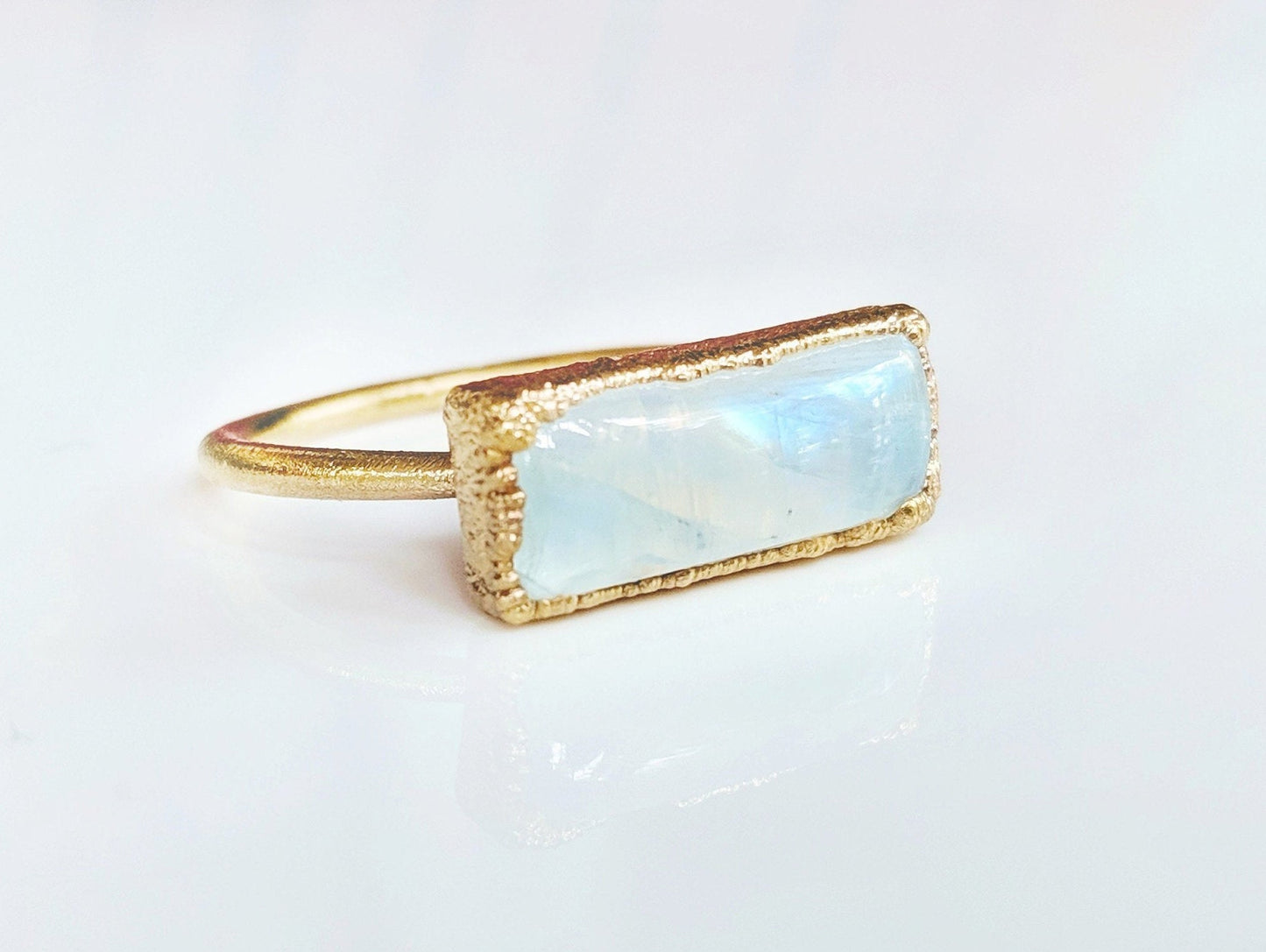Natural rainbow Moonstone ring set in 14k gold filled band, symbolizing new beginnings and feminine energy.