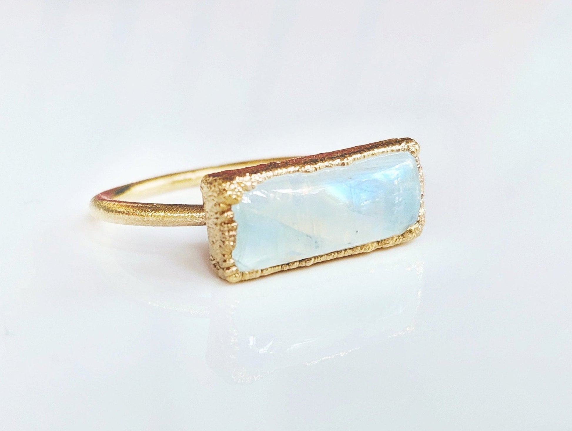 Natural rainbow Moonstone ring set in 14k gold filled band, symbolizing new beginnings and feminine energy.