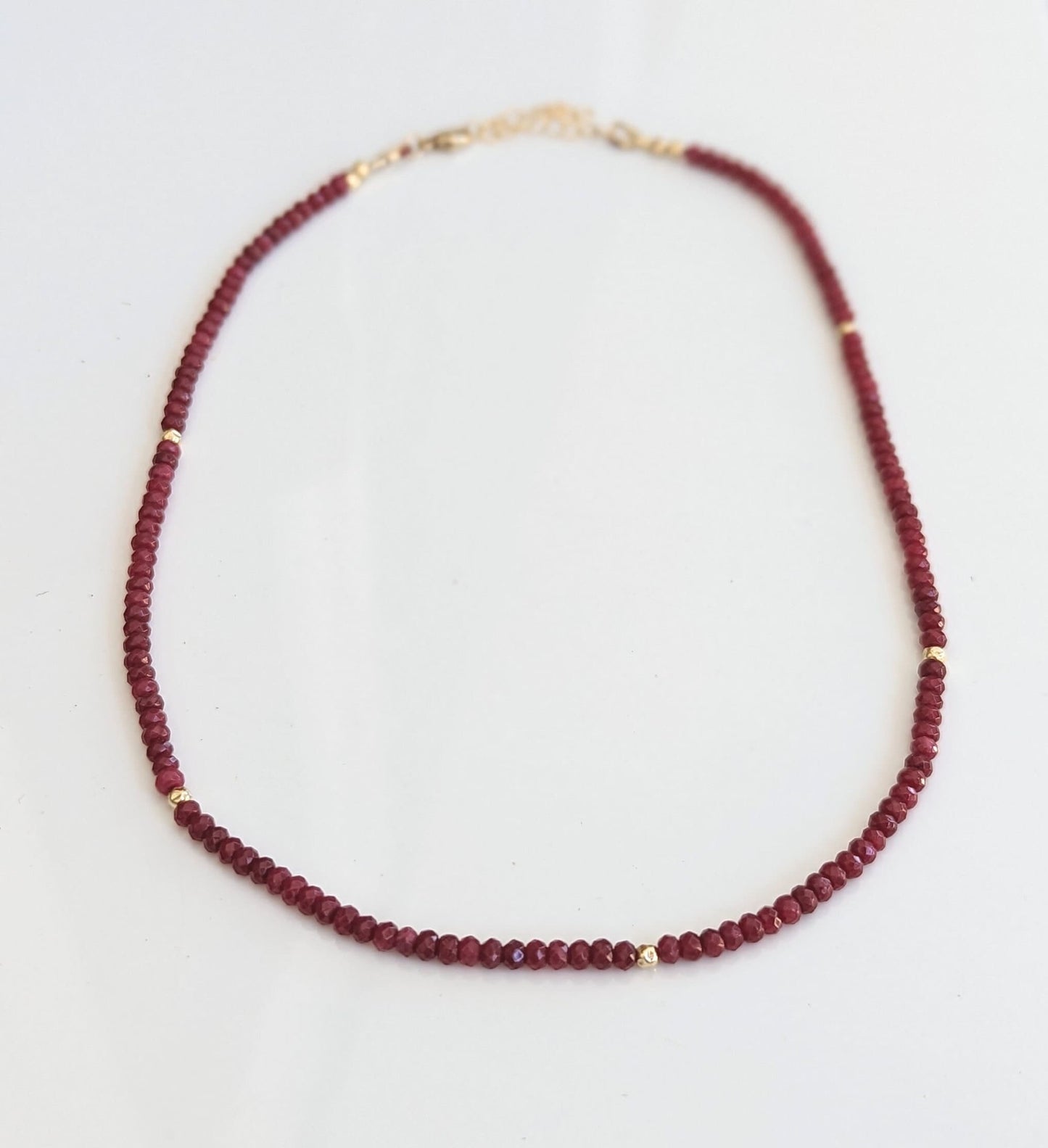 Handmade Ruby beaded necklace featuring deep pink Ruby beads and gold accents, perfect for any occasion.