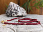 Handmade ruby beaded necklace featuring deep pink beads and gold accents, perfect for gifts and special occasions.