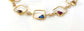 Personalized family birthstone necklace featuring colorful raw gemstones in gold square links.