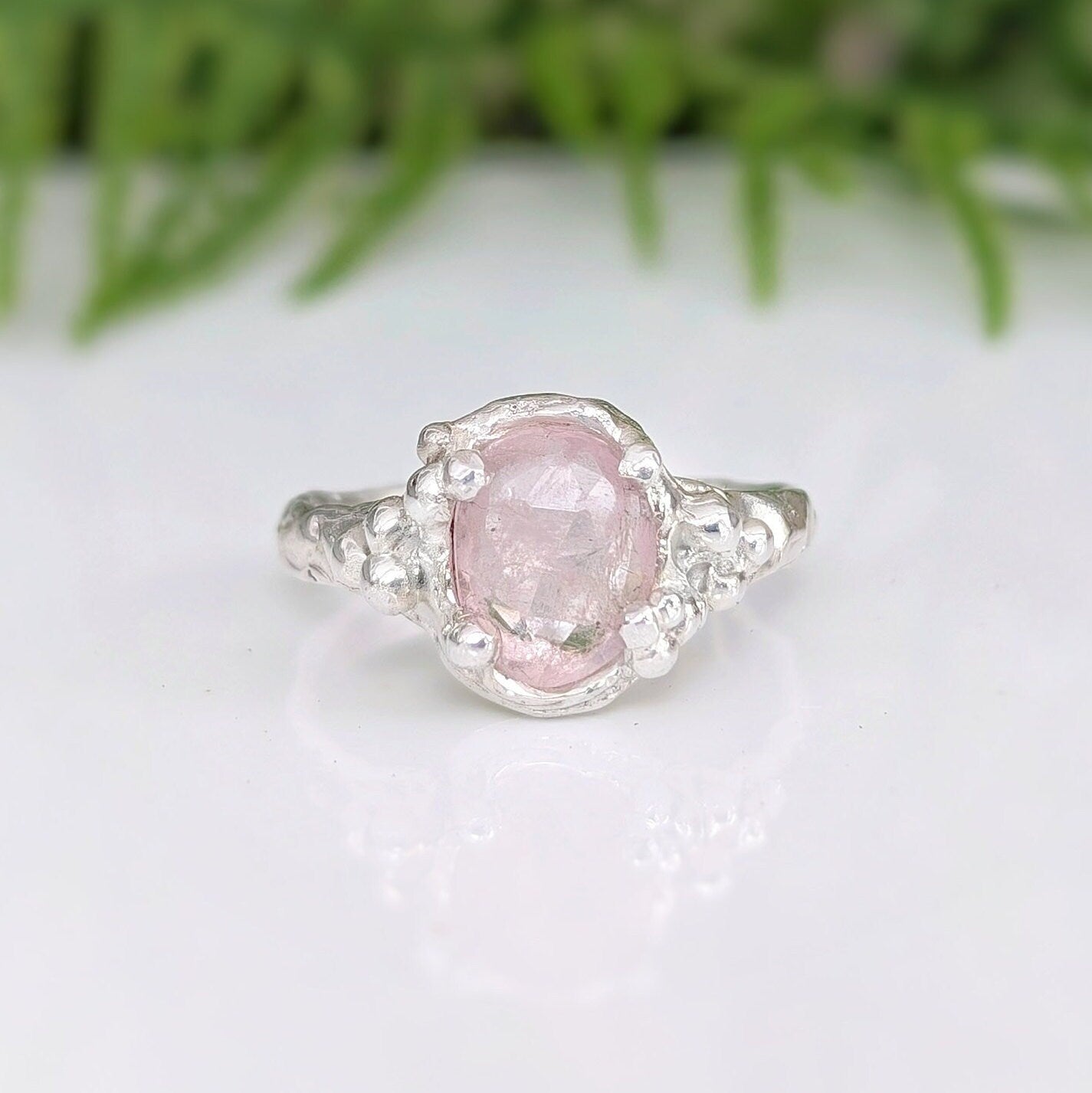 Pink Morganite engagement ring with sterling silver nature-inspired band, featuring an oval rose cut stone.