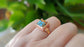 Pink Opal copper turquoise ring on a hand, showcasing a 10mm square gemstone on a 14k gold filled band.