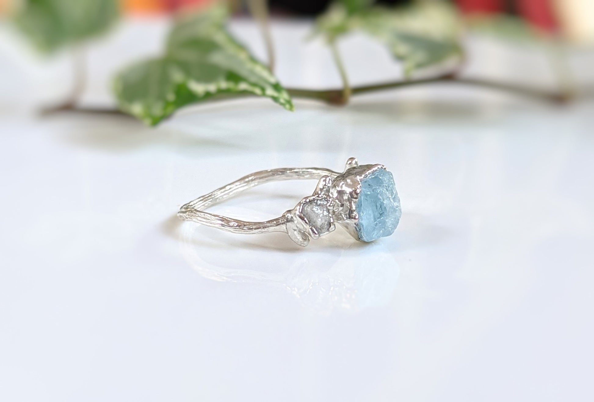 Unique Raw Aquamarine and diamond twig ring on a silver band, perfect for nature lovers and engagement.