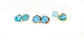 Raw Aquamarine stud earrings in gold and silver settings, showcasing unique rough stone shapes and vibrant blue hues.