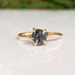 Raw black diamond engagement ring on a solid 14k gold band with prong settings, showcasing unique rustic elegance.