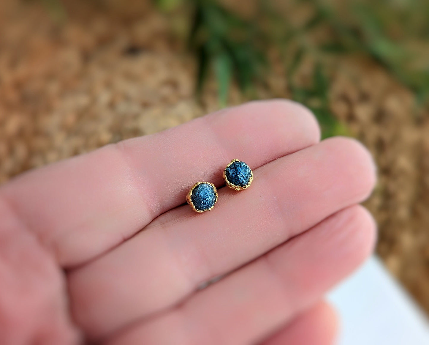 Handcrafted raw blue diamond stud earrings set in gold, perfect for bridal or casual wear, showcasing unique elegance.