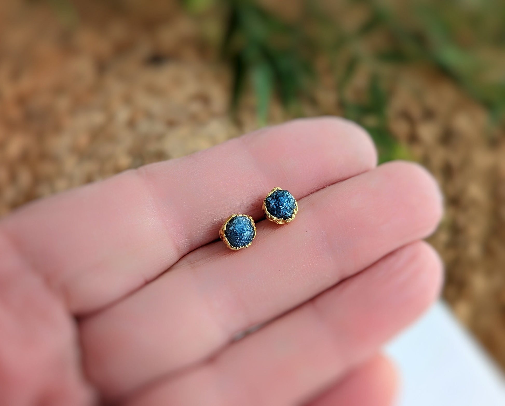 Handcrafted raw blue diamond stud earrings set in gold, perfect for bridal or casual wear, showcasing unique elegance.