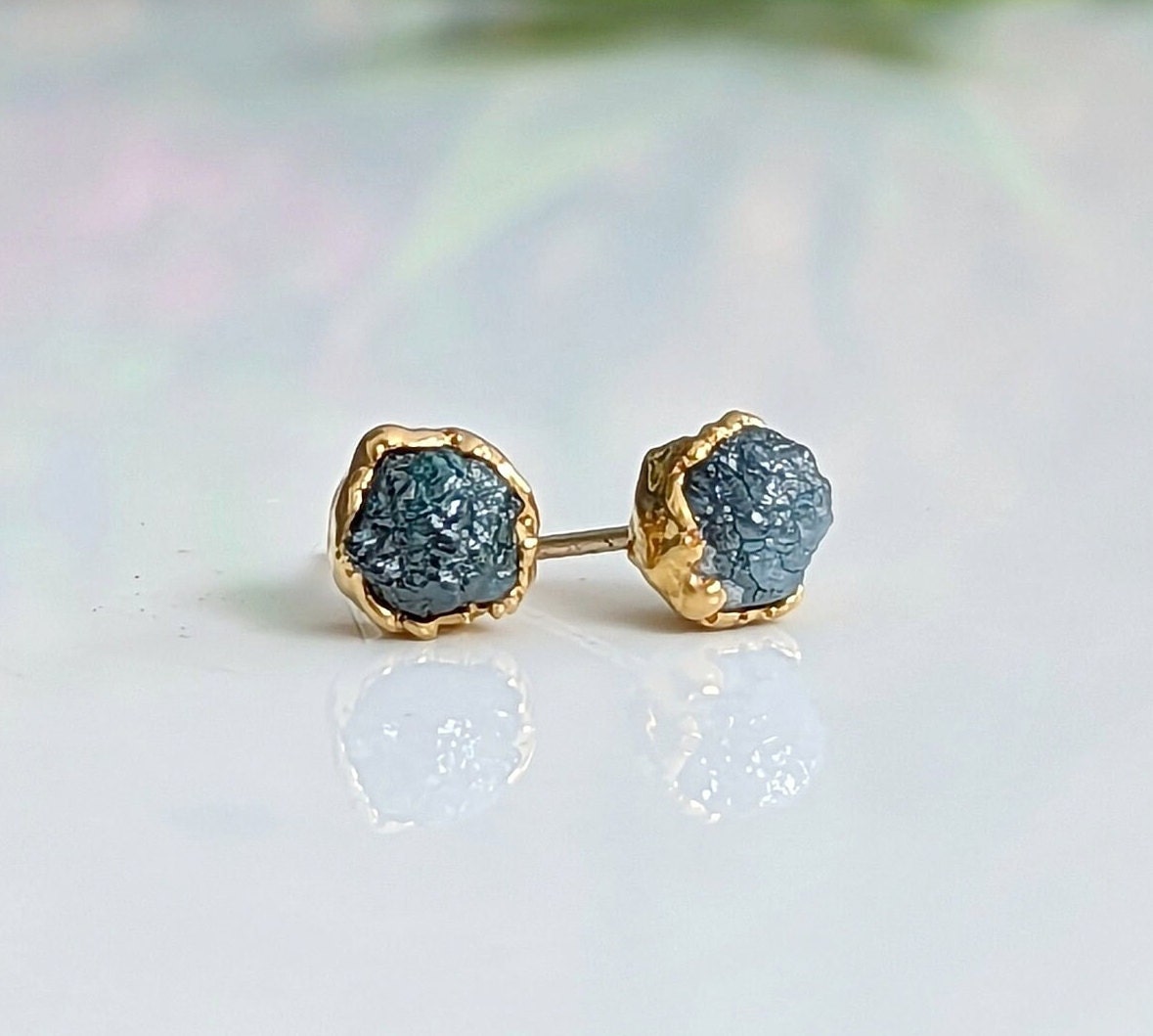 Handcrafted raw blue diamond stud earrings in gold setting, perfect for bridal or casual wear.